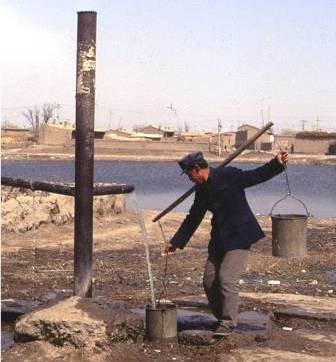 A man collecting artesian groundwater, rural Inner Mongolia