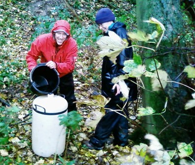 Collecting water samples in a wooded area