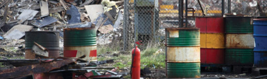 Scrap metal yard with rusty oil or chemical drums. (©  iStock/SoopySue)
