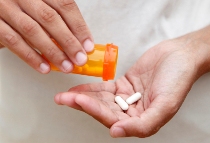 Person holding medicine tablets ©iStockphoto.com/amphotora