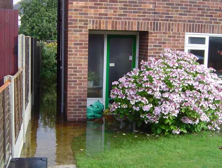House and garden flooded by rising groundwater, July 2007