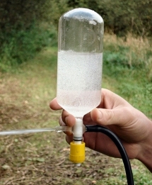 Sampling dissolved gases in groundwater with an evacuated flask.