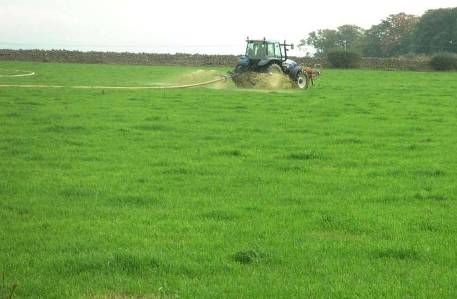 Tractor spraying a field